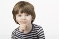 Smart little boy with serious thinking face the white background.