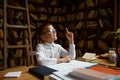 Smart little boy student having idea sitting at table desk in home library Royalty Free Stock Photo