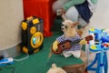 A smart little dog dressed up as a cute musician, a dog playing guitar on a shopping mall