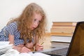 Smart little girl writes diploma. Royalty Free Stock Photo