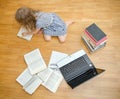 Smart little girl writes diploma at home. Royalty Free Stock Photo