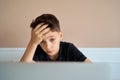 Smart looking boy doing his homework and look at computer notebook at home due to Covid-19 pandemic and social Royalty Free Stock Photo