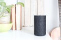 Smart loudspeaker in a self of a livingroom. Next, a guitar, books and floral decoration. Empty copy space Royalty Free Stock Photo