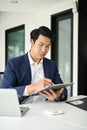 Smart male boss signing his signature on a contract while working in the office Royalty Free Stock Photo