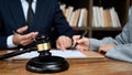 Smart male lawyer having a meeting with his client on the office. Judge gavel is on the table Royalty Free Stock Photo