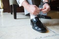 Smart man fastening shoelace Royalty Free Stock Photo