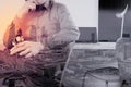 smart medical doctor holding stethoscope and thinking with laptop computer on dark wooden desk in modern office Royalty Free Stock Photo