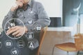 smart medical doctor holding stethoscope and thinking with laptop computer on dark wooden desk in modern office with virtual icon Royalty Free Stock Photo