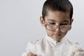 A smart mixed raced boy wearing glasses