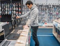 Modern male customer choosing laptop in the computer shop