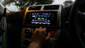 Smart multimedia touchscreen radio panel during the rain and hand holding gear stick Royalty Free Stock Photo