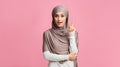 Smart muslim woman in headscarf pointing finger up, found problem solution