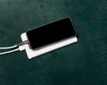 Smart phone  black mock screen with connect wire charger usb to emergency power bank Royalty Free Stock Photo