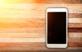 Smart phone with blank screen lying on table Royalty Free Stock Photo