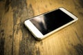Smart phone with blank screen lying on table Royalty Free Stock Photo