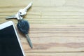 Smart phone, car remote key and keys on the wooden background Royalty Free Stock Photo