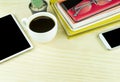 Smart phone,coffee cup,and stack of book on wooden table Royalty Free Stock Photo