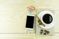 Smart phone, coffee,glasses and book blank with white pen on woo Royalty Free Stock Photo