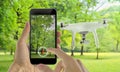 Smart phone control drone with app. Park in background Royalty Free Stock Photo