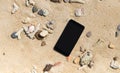 Smart phone with empty screen on tropical sand beach Royalty Free Stock Photo