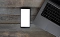 Smart phone with empty screen on wooden desk. Top view Communicator Technology On Wood Table Top View Royalty Free Stock Photo