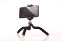 Smart phone with flexible tripod  on the white background Royalty Free Stock Photo