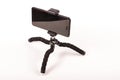 Smart phone with flexible tripod isolated on the white background