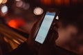 Smart phone in girl's hands at night Royalty Free Stock Photo