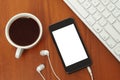 Smart phone with headphones, keyboard and coffee cup Royalty Free Stock Photo