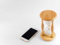 Smart phone and hourglass isolate on white Royalty Free Stock Photo