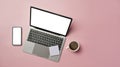Smart phone, laptop computer, sticky notes and coffee cup on pink background. Copy space for your text Royalty Free Stock Photo
