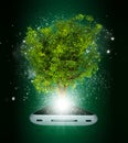 Smart phone with magical green tree and rays of