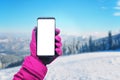 Smart phone mockup in girl hand with glove. Concept of using a phone at a ski resort