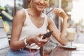 Smart phone online shopping in woman hand. Desk with coffee in background. Hands holding credit card and using mobile smart phone Royalty Free Stock Photo