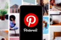 Smart phone with the Pinterest logo that is a platform that allows users to create and manage different themes.