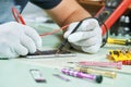 Smart phone repair. repairman testing electric circuit