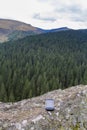 Smartphone on a rock in a mountain landscape. Royalty Free Stock Photo