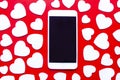 A smart phone surrounded by white hearts on a red background. ValentineÃ¢â¬â¢s Day Royalty Free Stock Photo