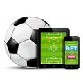 Smart phone and tablet with football field for betting online concept Royalty Free Stock Photo