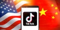 Smart phone with TIK TOK logo on National flags of the United States and China