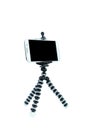 Smart Phone with a tripod on isolated white background. Royalty Free Stock Photo