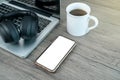 Smart phone white mock up screen. Working place office desk. Flat lay workspace with laptop cup of coffee on wooden background Royalty Free Stock Photo