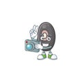 Smart Photographer black beans cartoon mascot with a camera