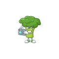 Smart Photographer green broccoli cartoon mascot with a camera