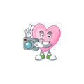 Smart Photographer pink love cartoon mascot with a camera