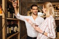 Smart positive man recommending wine to the client Royalty Free Stock Photo
