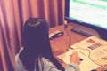 Smart preteen schoolgirl doing her homework with digital tablet at home. Child using gadgets to study. Education and learning for Royalty Free Stock Photo