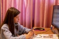 Smart preteen schoolgirl doing her homework with digital tablet at home. Child using gadgets to study. Education and learning for