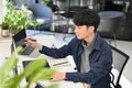 Smart Asian male programmer or web developer working at his office desk. side view Royalty Free Stock Photo