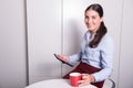 Smart professonal woman is looking on tablet during coffee break